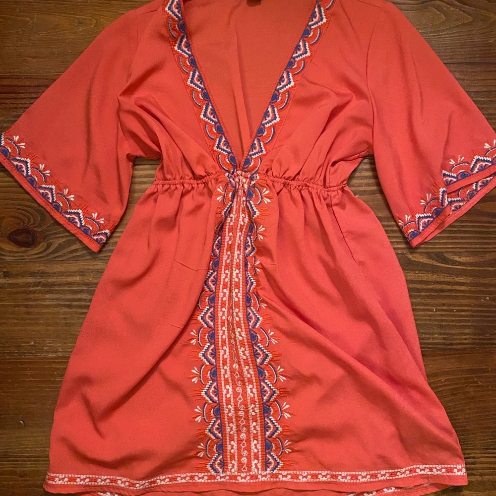 Embroidered detail on bell sleeves and throughout.